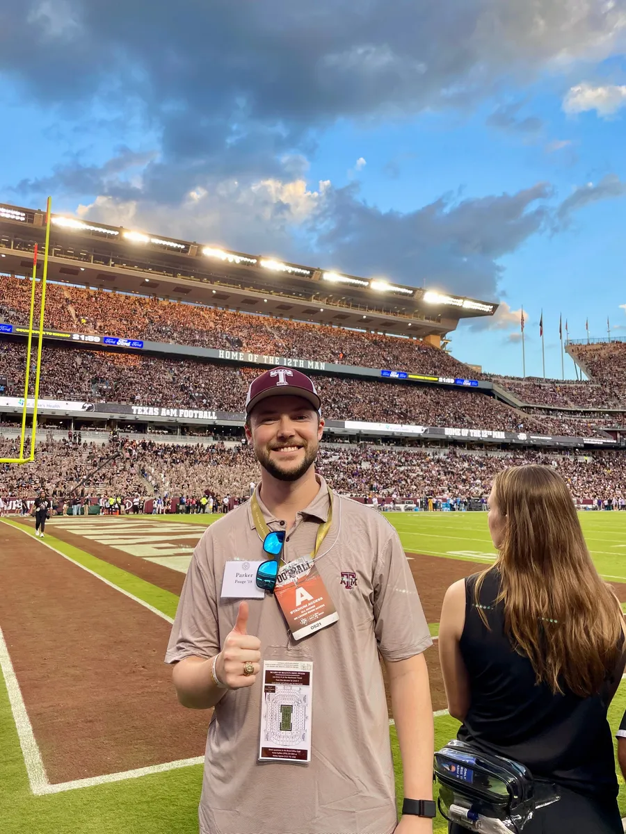 Parker giving a thumbs up from the sideline at Kyle Field before a Texas A&M football game.
