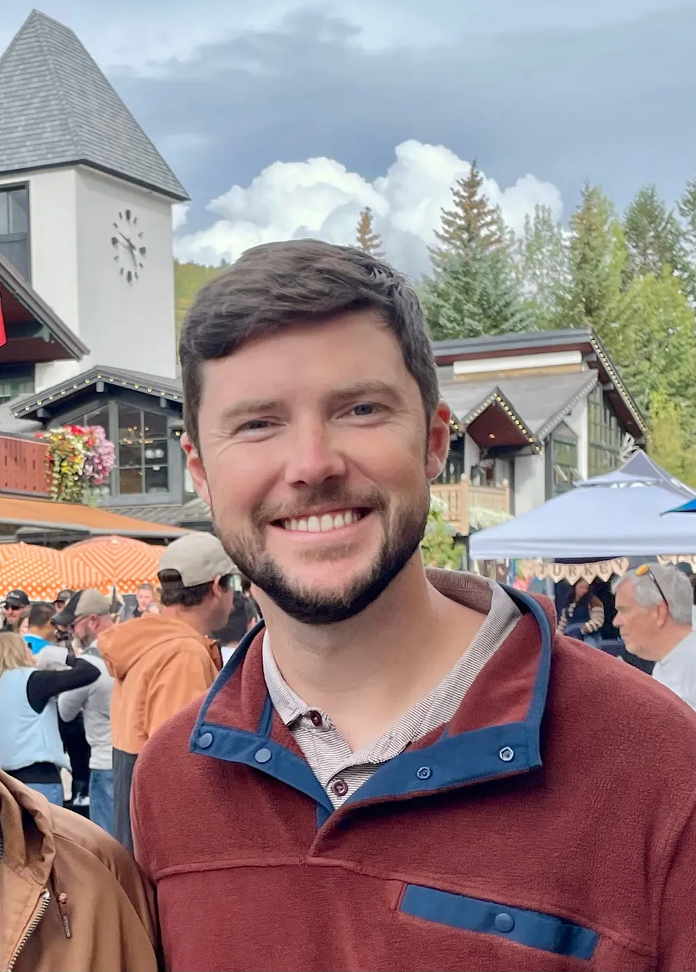 Parker Poage smiling in Vail Village on an overcast afternoon.
